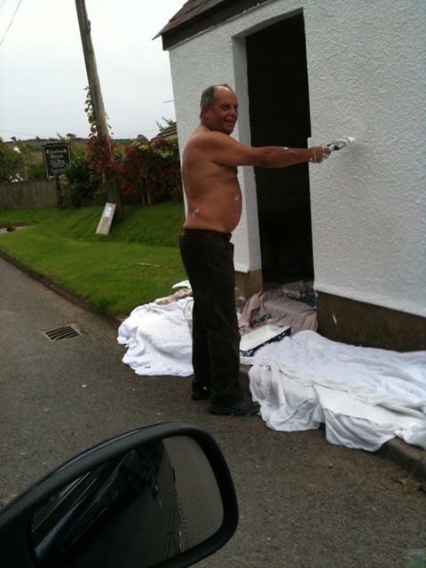 Sparky Brooks painting the bus shelter in Littleham
